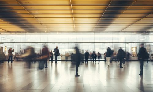 Crowd of people walking through an airport, motion blur